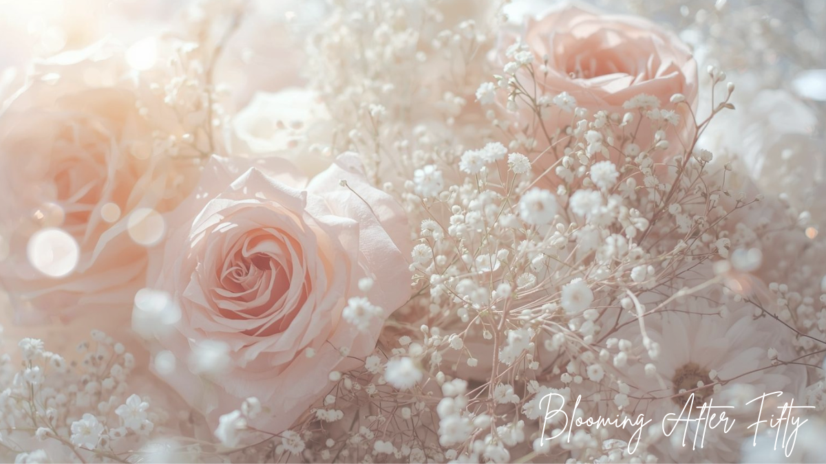 3 delicate pink roses in bloom nestled in a bunch of Baby's Breath flowers.